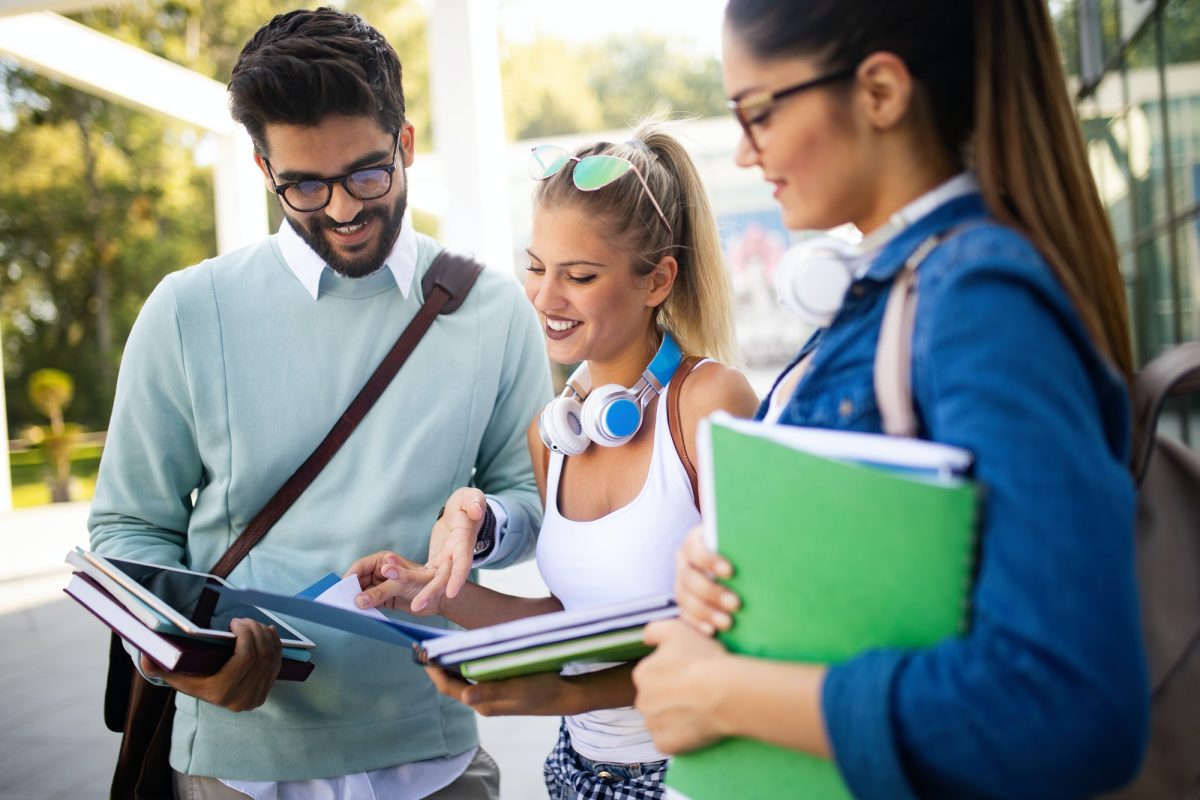 happy-young-university-students-friends-studying-with-books-at-university-2.jpg